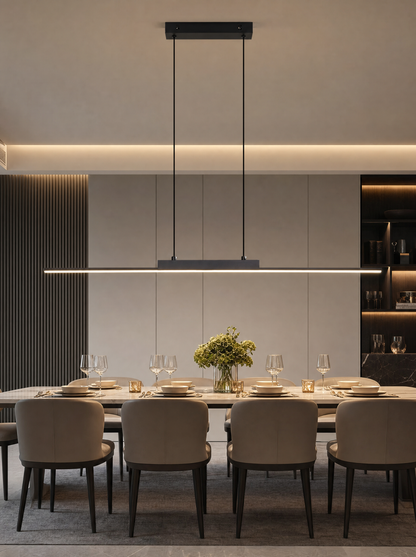 The Lumen Linear Pendant in black lit above a dining table